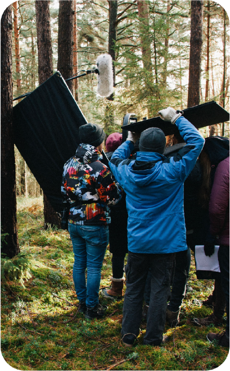 Film crew in remote location using satellite equipment for TV and documentary production